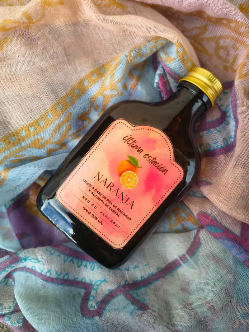 Licor artesanal de naranja de Última Estación en vista lateral, con la etiqueta a la vista